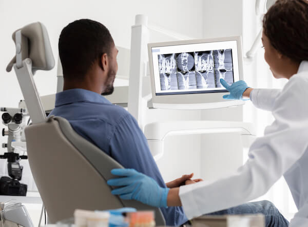 orthodontist showing patient scans
