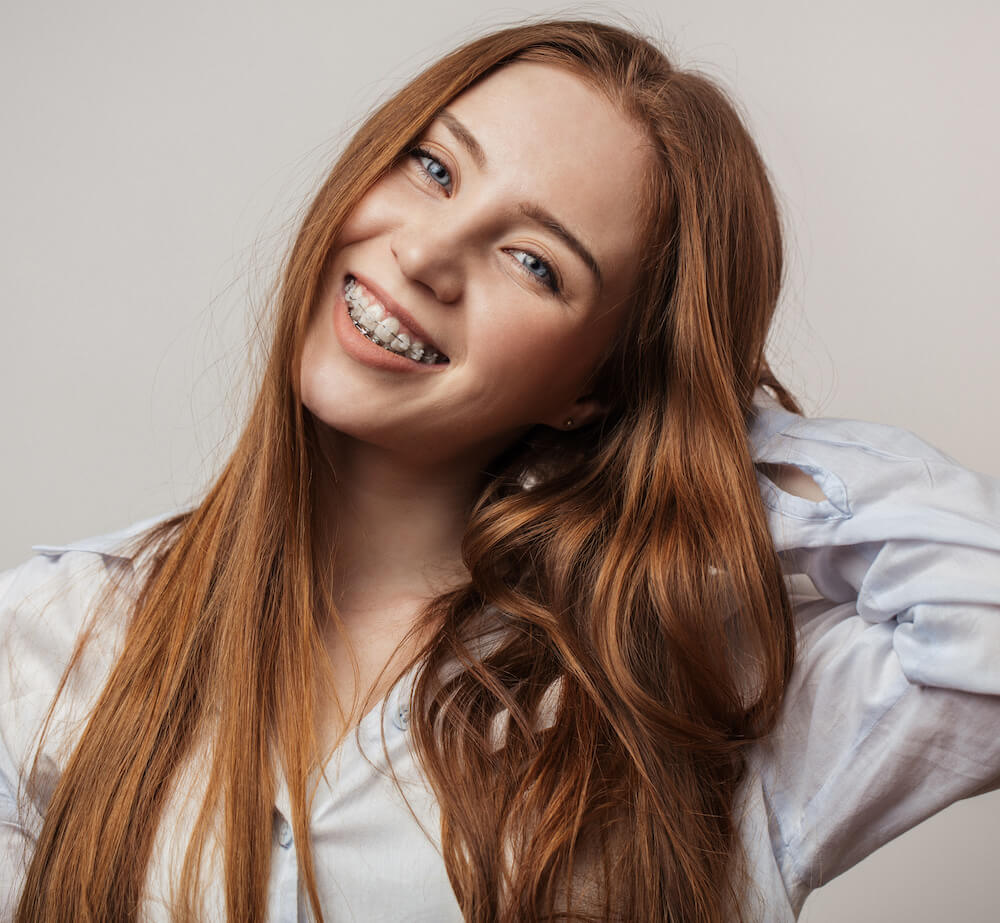 smiling teenage girl with clear braces