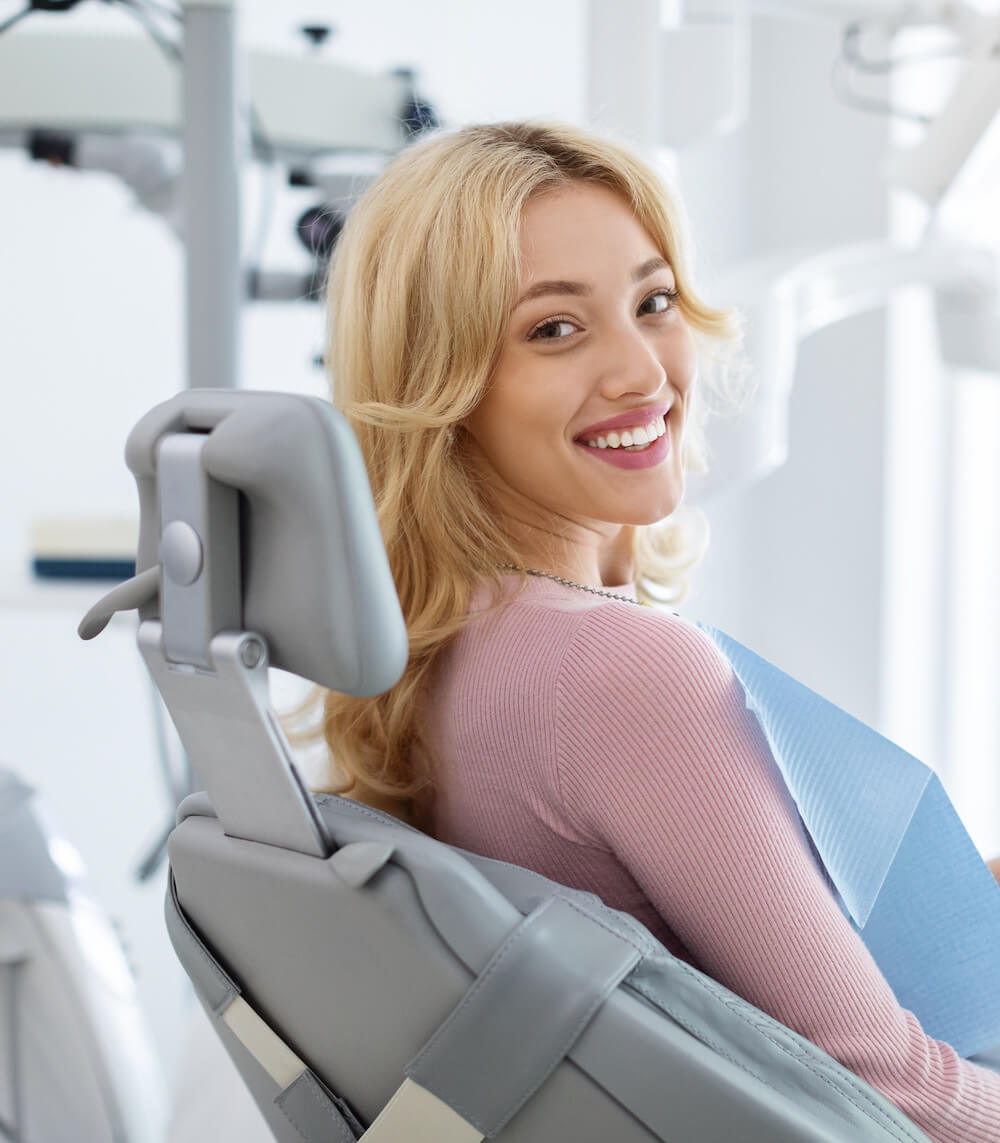 young woman on dental chair smiling