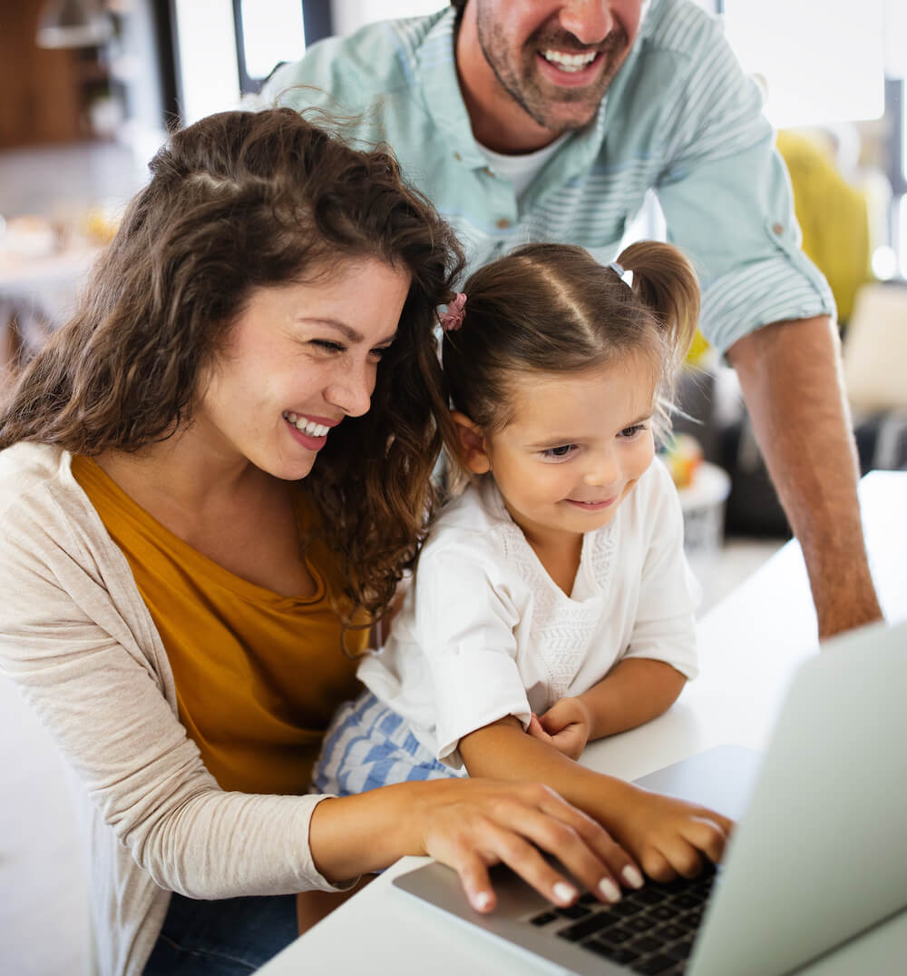 family looking at laptop